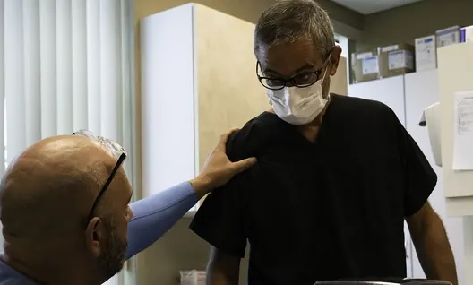 One of our dentists talking with a patient in the treatment room.