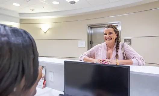 A patient chatting with the front desk team.