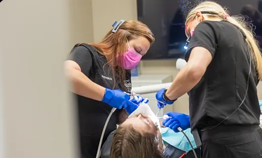 Two of our team treating a patient in a Little Rock Family Dental Care operatory.