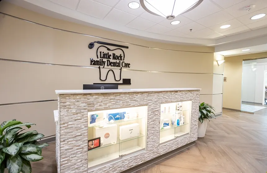The reception desk, with the practice's sign on the wall behind it.